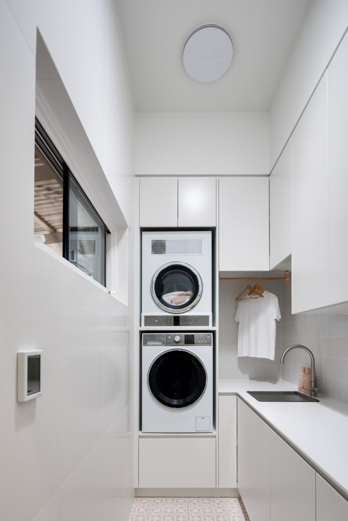 Small laundry renovation in Perth home with stacked washer and custom cabinetry